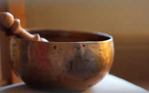 Bronze singing bowl sitting on a table - an ideal tool for use in meditation