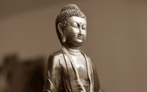 silver buddha statue in meditation